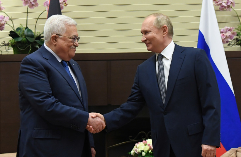  Russian President Vladimir Putin shakes hands with Palestinian President Mahmoud Abbas during their meeting in Sochi, Russia November 23, 2021. (photo credit: SPUTNIK/EVGENY BIYATOV/KREMLIN VIA REUTERS)