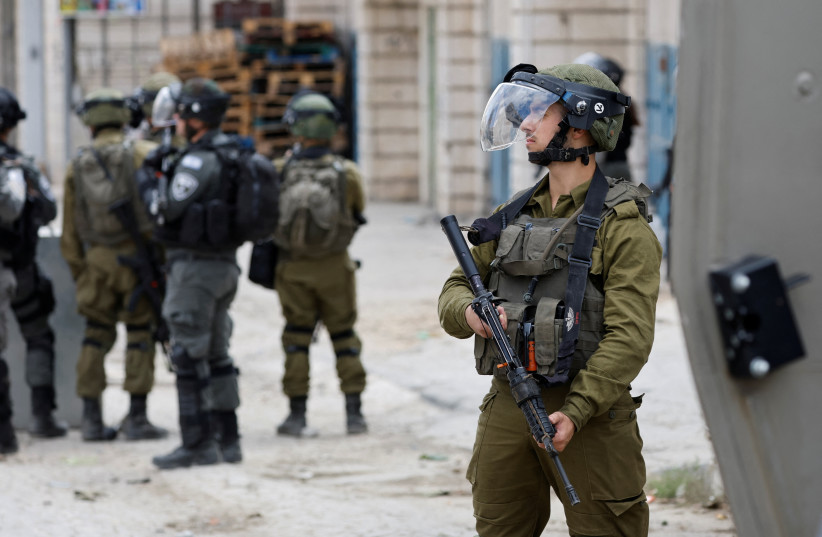  Israeli forces stand guard in the West Bank, October 13, 2022. (credit: REUTERS/MUSSA QAWASMA)