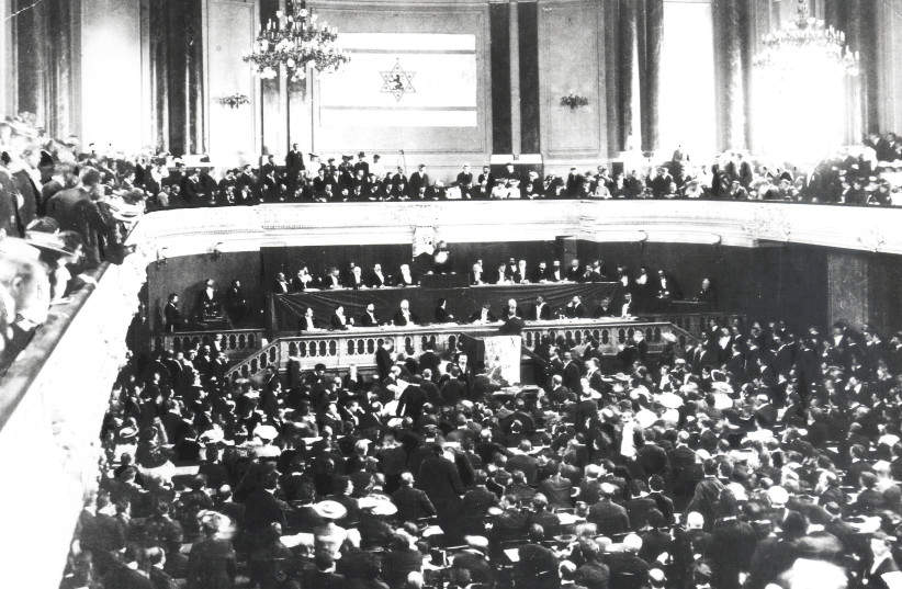  OPENING OF the Second Zionist Congress in Basel, Switzerland, August 1898. On the podium, center stage, Herzl is seen indistinctly, delivering the keynote address.  (credit: Wikimedia Commons)