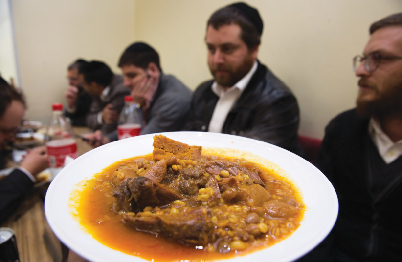  CHANGED CULINARY traditions: Cholent being consumed in Mea She’arim (Illustrative).  (credit: NATI SHOHAT/FLASH90)