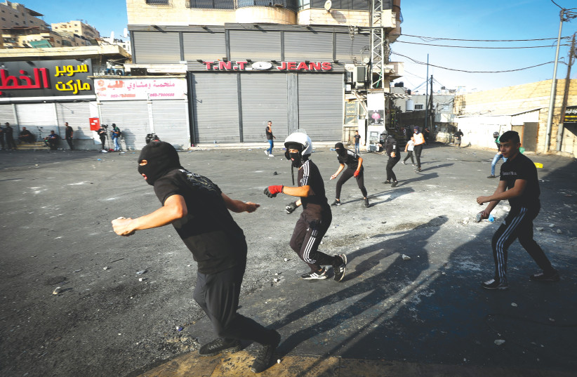  PALESTINIAN YOUTHS clash with Israeli security forces in the Shuafat refugee camp in northern Jerusalem, this week.  (photo credit: JAMAL AWAD/FLASH90)