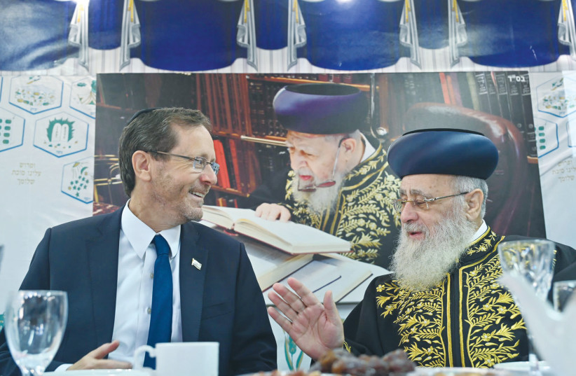  PRESIDENT ISAAC Herzog and Sephardi Chief Rabbi Yitzhak Yosef share a humorous moment in the rabbi’s sukkah.  (photo credit: KOBI GIDEON/GPO)