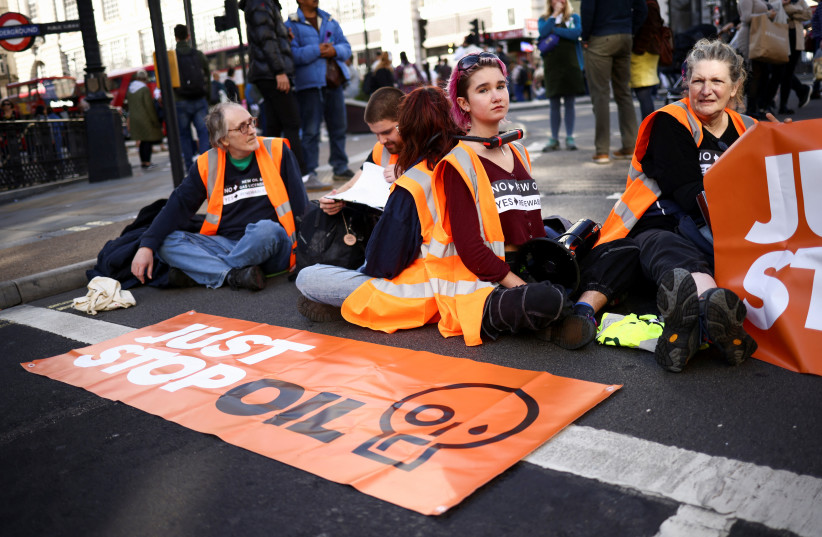 Demonstrators participate in a ''Just Stop Oil'' protest in London, Britain, October 9, 2022.  (credit: REUTERS/HENRY NICHOLLS)