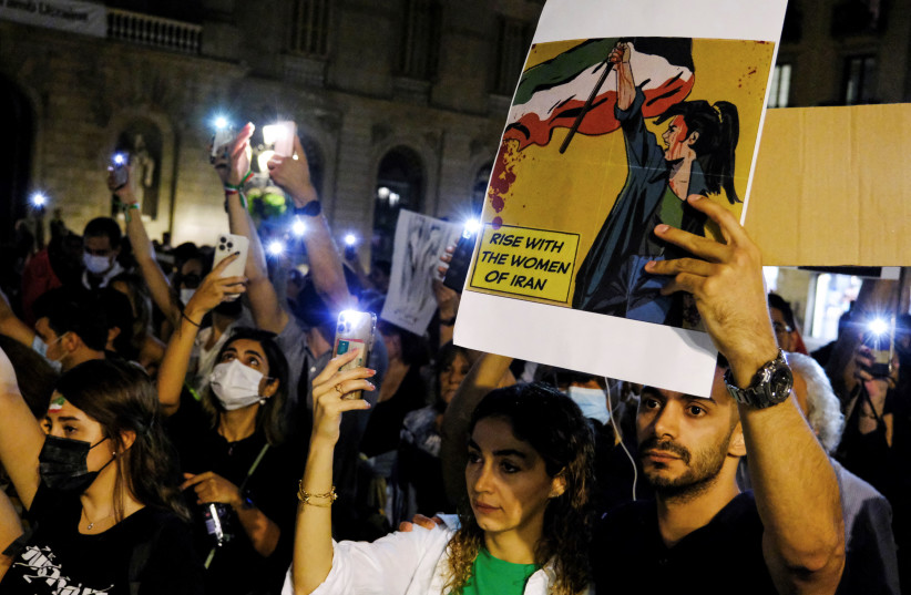  Iranian citizens and locals protest in support of Iranian women and against the death of Mahsa Amini, in Barcelona, Spain, October 15, 2022. (credit: NACHO DOCE/REUTERS)