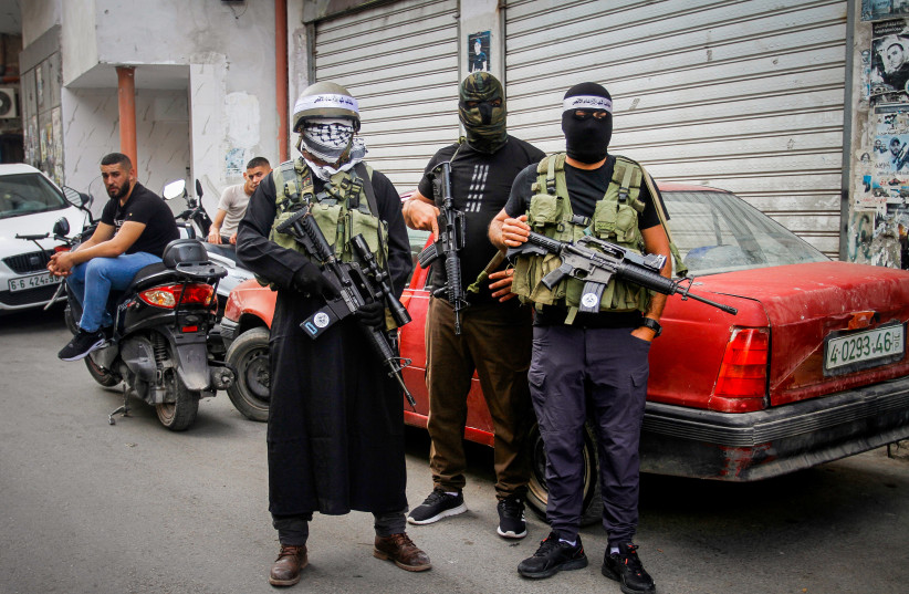  Palestinian gunmen and mourners attend the funeral of Palestinian Islamic Jihad activist Matin dabaya, who was killed during clashes with Israeli forces, during his funeral in Jenin, in the West Bank, October 14, 2022.  (credit: NASSER ISHTAYEH/FLASH90)