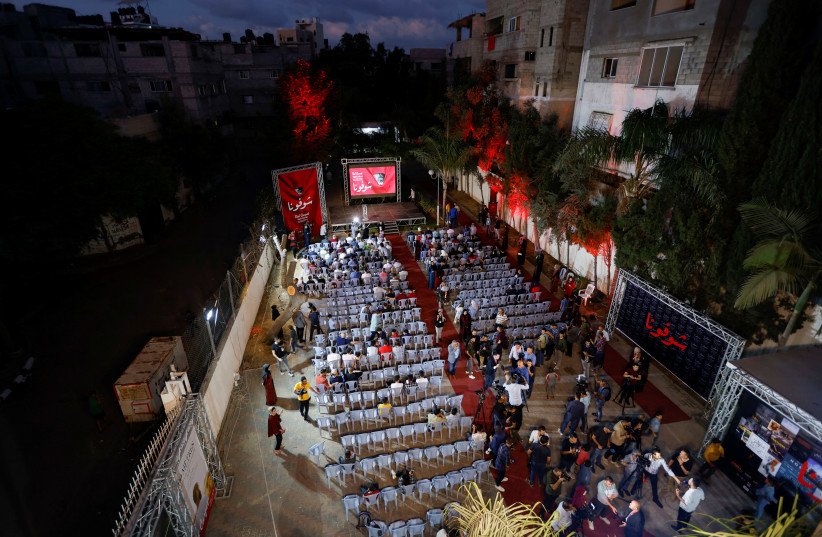 Palestinians watch the sixth edition of the Red Carpet Film Festival, at a newly renovated theatre in Gaza City, October 13, 2022. (credit: REUTERS/IBRAHEEM ABU MUSTAFA)