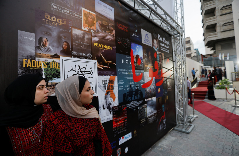  Palestinian volunteers participate in organising the sixth edition of the Red Carpet Film Festival, at a newly renovated theatre in Gaza City, October 13, 2022.  (credit: REUTERS/IBRAHEEM ABU MUSTAFA)