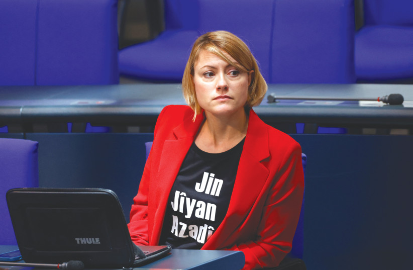  DIE LINKE Party member Clara Bünger attends a plenary session of the Bundestag last month, wearing a T-shirt that reads “women, life, freedom.” (photo credit: MICHELE TANTUSSI/REUTERS)