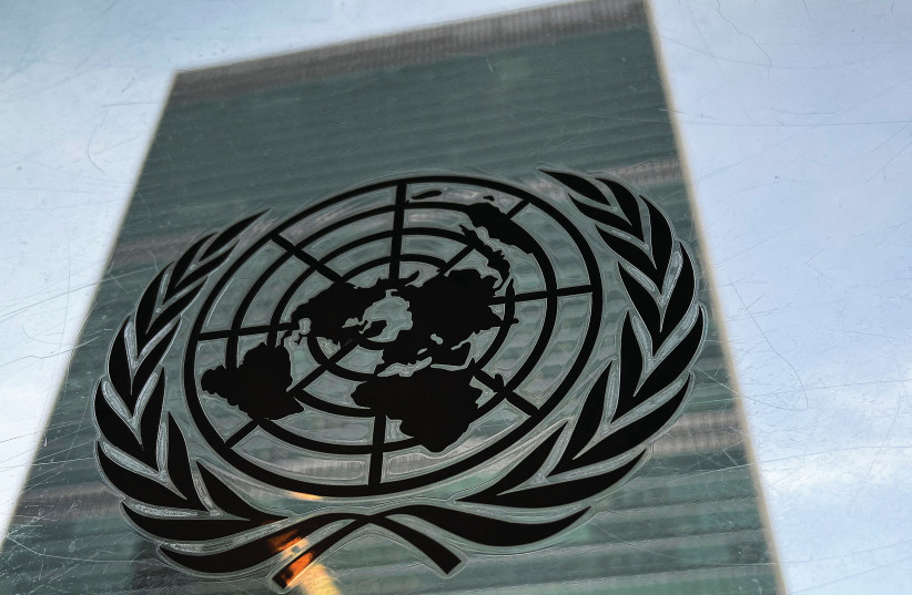  THE UNITED NATIONS headquarters building in New York City, and the UN logo: Today’s UN needs to be reimagined and reformed to address the limited problems it can effectively handle, says the writer. (photo credit: CARLO ALLEGRI/REUTERS)