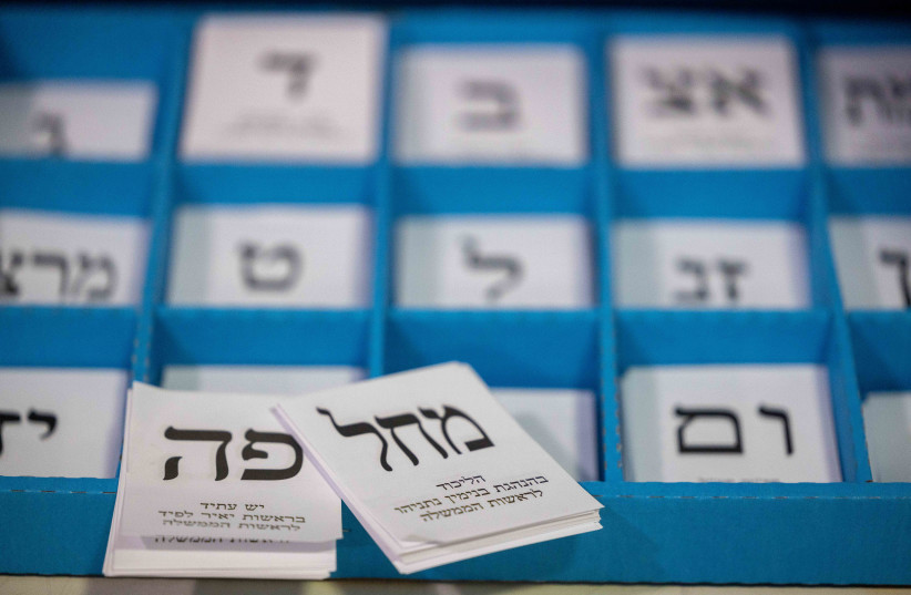  Workers prepare ballot boxes for the upcoming Israeli elections, at the central elections committee warehouse in Shoham, before they are shipped to polling stations, October 12, 2022. (photo credit: YONATAN SINDEL/FLASH90)