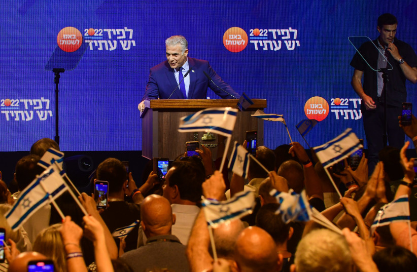  Prime Minister and Yesh Atid chairman Yair Lapid speaks to party members during a Yesh Atid party conference in Tel Aviv, August 3, 2022.  (photo credit: AVSHALOM SASSONI/FLASH90)