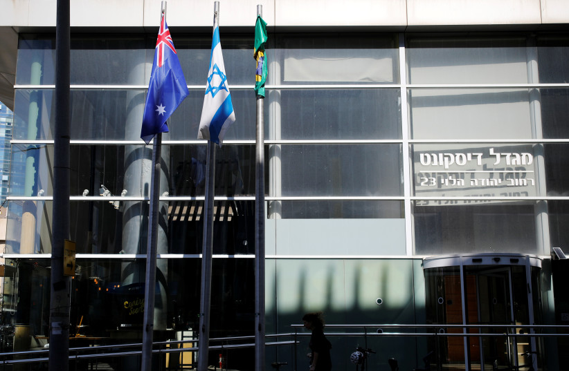  The national flags of Australia and Israel are seen outside the building housing the Australian Embassy in Tel Aviv, Israel October 16, 2018. (photo credit: REUTERS/AMIR COHEN)