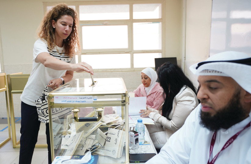  A WOMAN votes during Kuwaiti parliamentary elections at a polling station in Kuwait City, on September 29. (photo credit: Stephanie McGehee/Reuters)