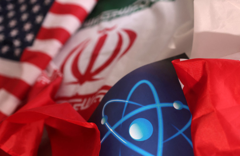  Atomic symbol and USA and Iranian flags are seen in this illustration taken September 8, 2022. (photo credit: DADO RUVIC/REUTERS ILLUSTRATION)