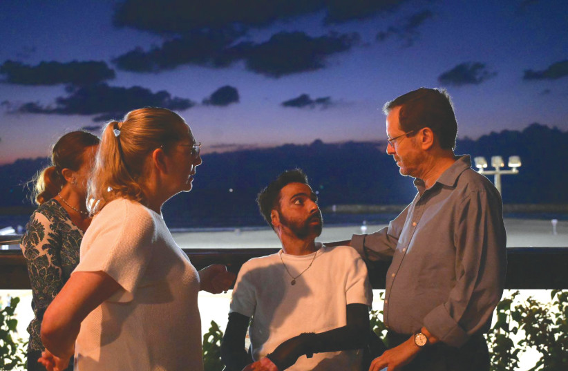  PRESIDENT ISAAC HERZOG and his wife, Michal (front left), with Itzik Saidian. (credit: AMOS BEN GERSHOM/GPO)