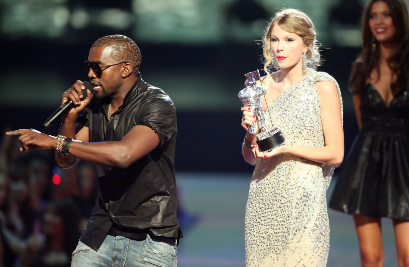  Kanye West (L) jumps onstage after Taylor Swift (C) won the ''Best Female Video'' award during the 2009 MTV Video Music Awards at Radio City Music Hall on September 13, 2009 in New York City. (credit: CHRISTOPHER POLK/GETTY IMAGES)