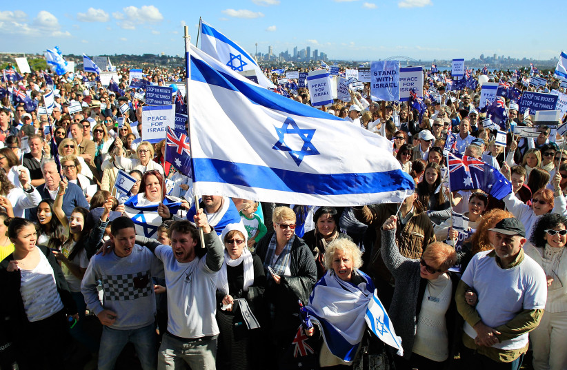   A man waves an Israel flag during a Pro-Israeli rally at Dudley Page Reserve on August 3, 2014 in Sydney, Australia.  (credit: DANIEL MUNOZ/GETTY IMAGES)