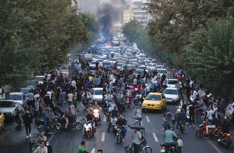  TAKING TO the streets in Tehran (L) to protest the death of Mahsa Amini in Iranian morality police custody, late September. (credit: AFP VIA GETTY IMAGES)