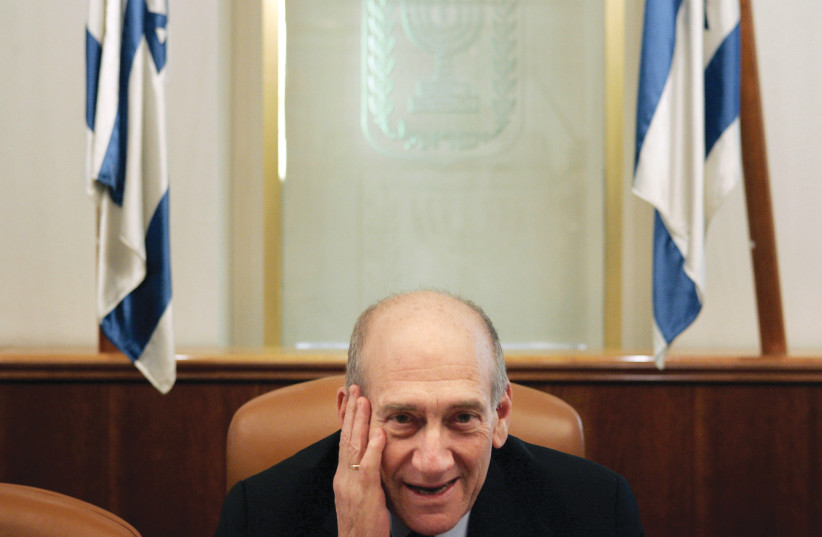  THEN-PRIME MINISTER Ehud Olmert attends a 2007 meeting in Jerusalem with Shoah survivors, following survivors’ rejection of suggested reparations from the government as too meager. The book relates to such reparations.  (credit: Yonathan Weitzman/Reuters)