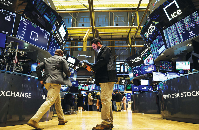  TRADERS WORK on the floor of the New York Stock Exchange last week. (credit: BRENDAN MCDERMID/REUTERS)