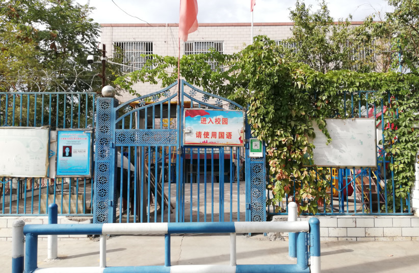 Entrance to a school in Turpan, a Uyghur-majority city in Xinjiang, in 2018. The sign at the gate, written in Chinese, reads: ''[You are] entering the school grounds. Please speak Guoyu [''the national language'', i.e. Mandarin Chinese]'' (credit: KUBILAYAXUN/CC BY-SA 4.0 (https://creativecommons.org/licenses/by-sa/4.0)/VIA WIKIMEDIA COMMONS)