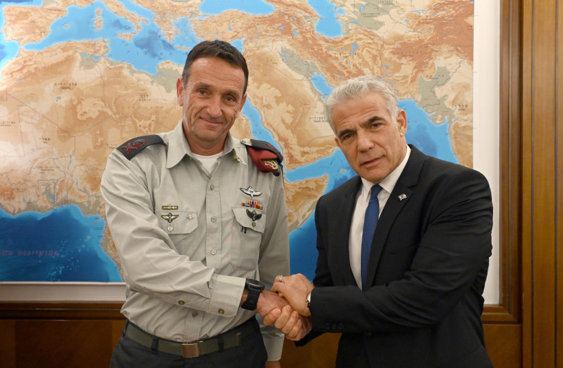  Israeli Prime Minister Yair Lapid (R) is seen shaking hands with incoming IDF Chief of Staff Hertzi Halevi, on October 23, 2022. (photo credit: HAIM ZACH/GPO)