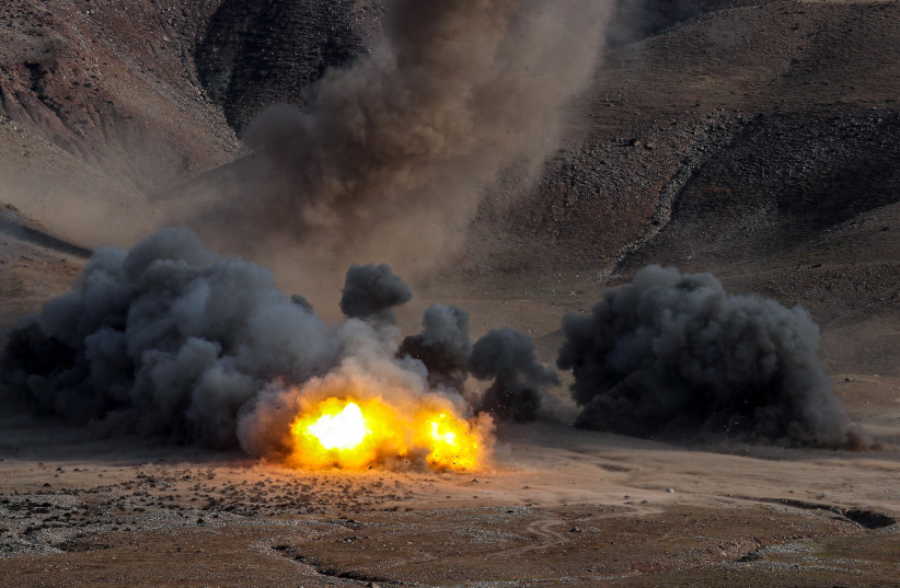  An explosion is seen during an Islamic Revolutionary Guard Corps (IRGC) ground forces military drill in the Aras area, East Azerbaijan province, Iran, October 19, 2022. (photo credit: IRGC/WANA (West Asia News Agency)/Handout via REUTERS)