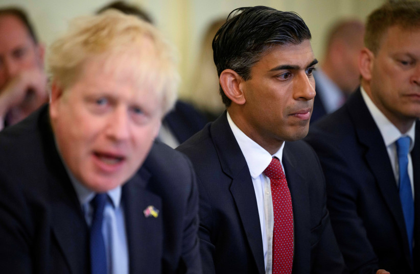  British Chancellor of the Exchequer Rishi Sunak listens as British Prime Minister Boris Johnson addresses his cabinet on the day of the weekly cabinet meeting in Downing Street, London, Britain June 7, 2022. (photo credit: LEON NEAL/POOL VIA REUTERS)