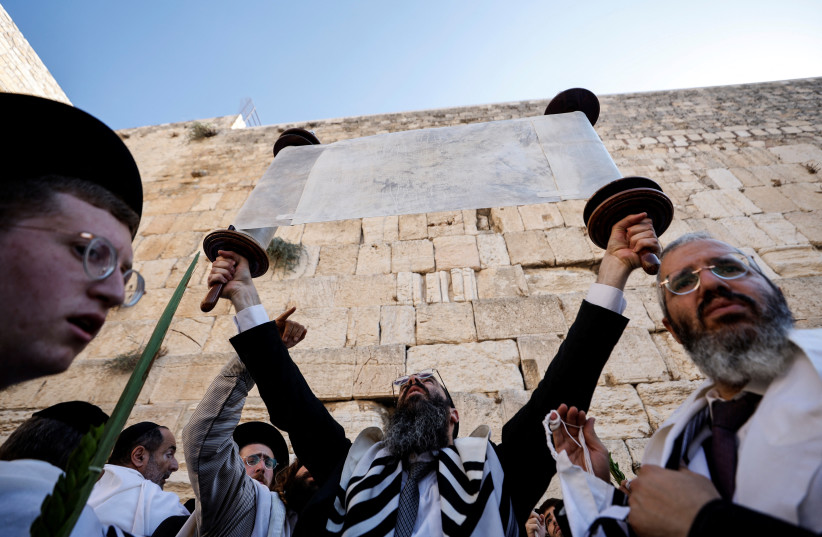 Torah scroll is raised and displayed at Western Wall (photo credit: REUTERS/AMIR COHEN)