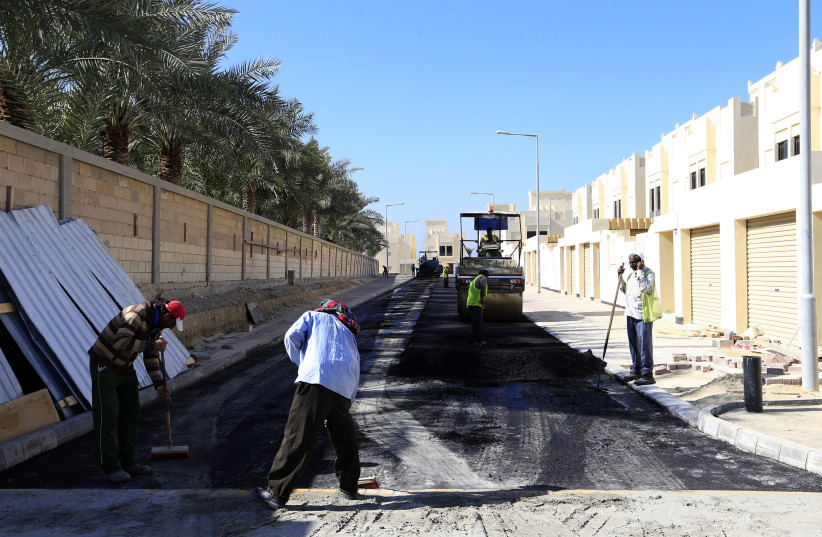  Workers are seen at a construction side in one of the government housing projects in Budaiya (credit: REUTERS)