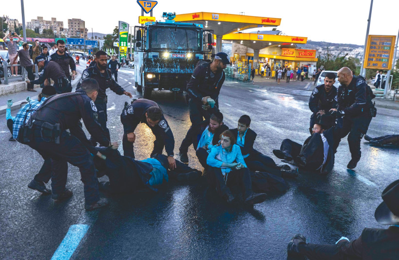  HAREDIM CLASH with police in Jerusalem as they protest over the arrest of brethren who failed to comply with their army draft, last month.  (photo credit: OLIVIER FITOUSSI/FLASH90)