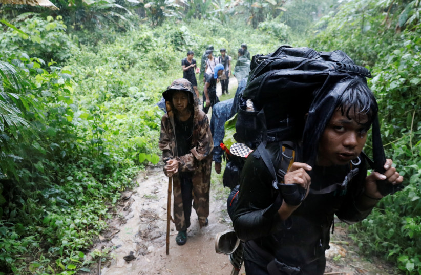  Members of the People's Defence Force (PDF) hike at a training camp in an area controlled by ethnic Karen rebels, Karen State, Myanmar, September 10, 2021. (credit: REUTERS/STRINGER)