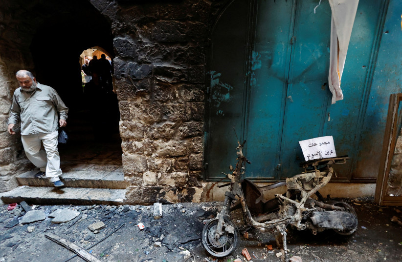 A burned vehicle is seen outside the house of Palestinian group Lions' Den member Wadee Al-Houh, which was targeted during a raid by Israeli security forces, in Nablus in the West Bank, October 25, 2022. (photo credit: REUTERS/RANEEN SAWAFTA)