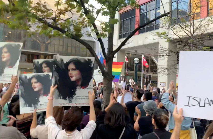   People attend a protest in solidarity with the women in Iran, following the death of Mahsa Amini, in Toronto, Canada, September 19, 2022. (photo credit: Reuters/Screenshot)