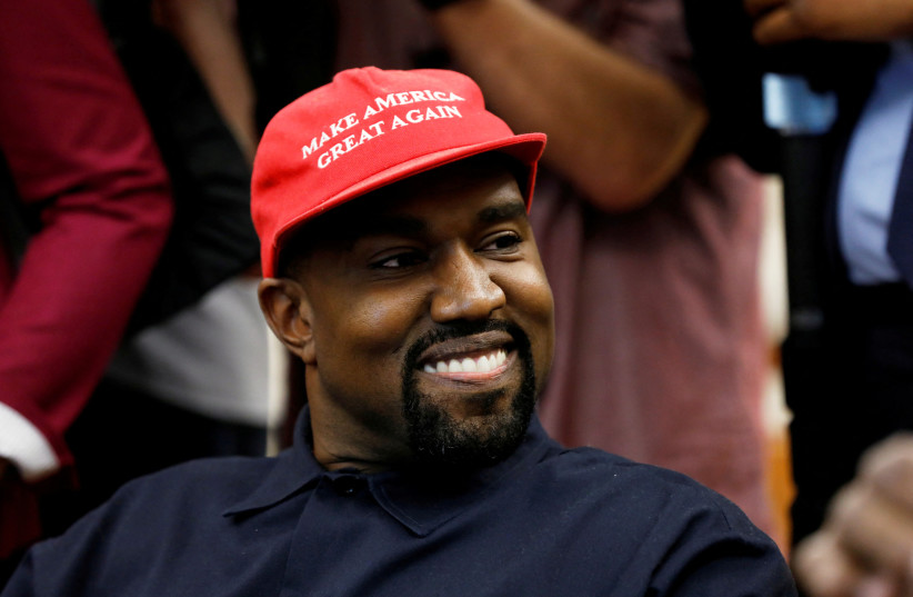 Rapper Kanye West smiles during a meeting with then-US President Donald Trump to discuss criminal justice reform at the White House in Washington, US, October 11, 2018.  (credit: REUTERS/KEVIN LAMARQUE/FILE PHOTO)