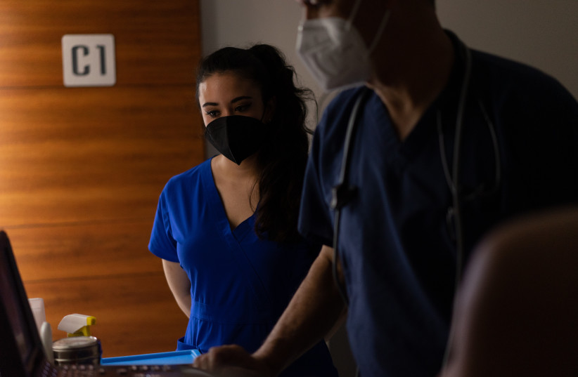  Doctors in face masks and scrubs (illustrative) (photo credit: PEXELS)