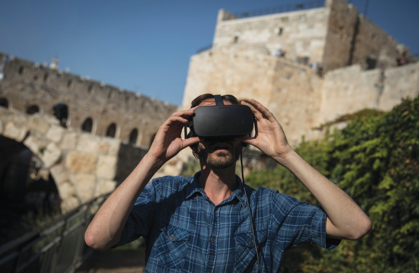  TAKING IN an Old City view through virtual reality glasses, at Jerusalem’s Tower of David.  (photo credit: HADAS PARUSH/FLASH90)