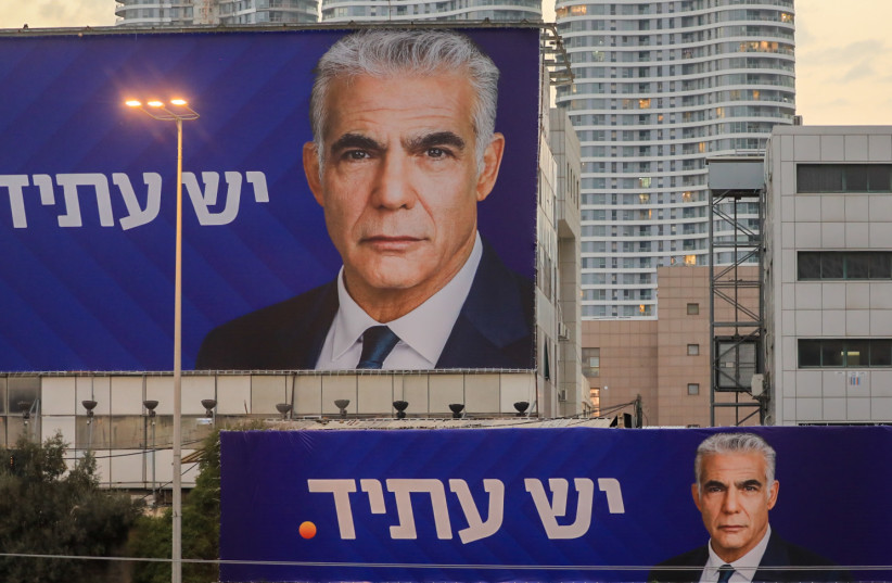  Campaign posters for Yair Lapid's Yesh Atid next to the Ayalon Highway in Tel Aviv, prior to the upcoming Israeli general elections, October 26, 2022.  (photo credit: JAMAL AWAD/FLASH90)