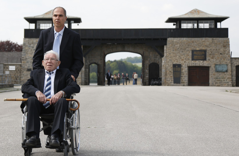  CONCENTRATION CAMP survivor Moshe Spitzer in front of Mauthausen, in Austria. SS doctor Josef Mengele selected him at Auschwitz as a worker to be sent there.  (photo credit: Leonhard Foeger/Reuters)
