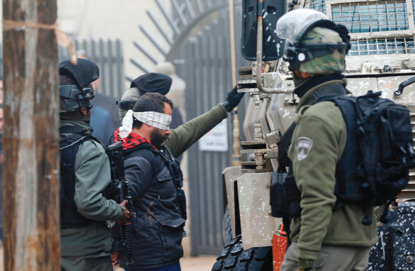  SECURITY FORCES arrest Palestinian lawyer Tareq Barghout for alleged involvement in terrorist activity in Ramallah, 2019. (credit: Abbas Momani/AFP via Getty Images)