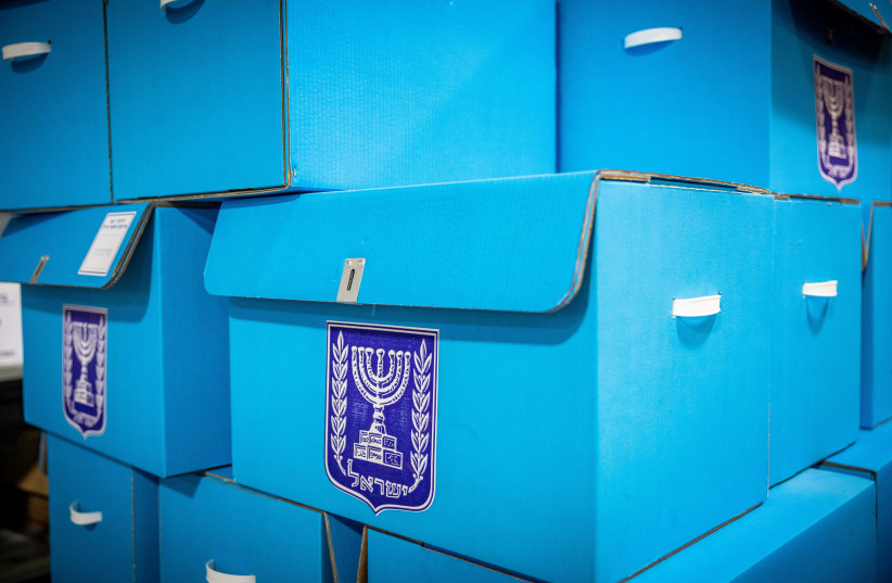  Workers prepare ballot boxes for the upcoming Israeli elections, at the central elections committee warehouse in Shoham, before they are shipped to polling stations, October 12, 2022. (photo credit: YONATAN SINDEL/FLASH90)