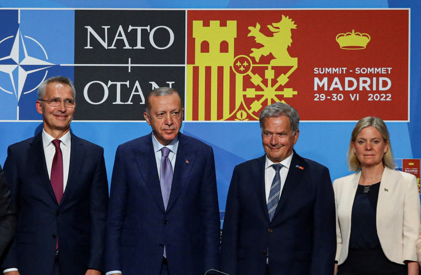 NATO Secretary General Jens Stoltenberg, Turkish President Tayyip Erdogan, Finland's President Sauli Niinisto and Sweden's Prime Minister Magdalena Andersson pose after signing a document during a NATO summit in Madrid, Spain, June 28, 2022. (photo credit: REUTERS/VIOLETA SANTOS MOURA/FILE PHOTO)