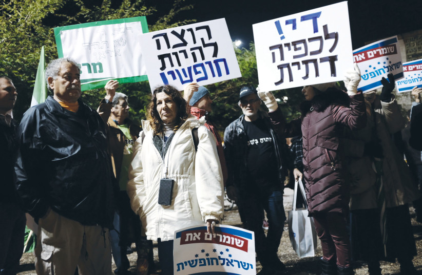  PROTESTERS HOLD signs with slogans against religious coercion, at a demonstration in Ramat Gan, 2018 (photo credit: REUTERS)
