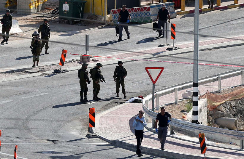  Israeli security forces gather near the entrance of the Jewish settlement of Kiryat Arba'a near the West Bank town of Hebron, on May 19, 2021 (photo credit: WISAM HASHLAMOUN/FLASH90)
