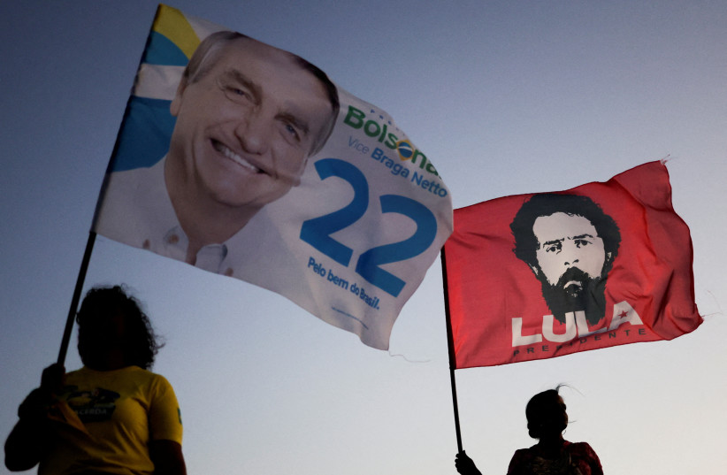 Supporters of Brazil's President and candidate for re-election Jair Bolsonaro and supporters of Brazil's former President Luiz Inacio Lula da Silva campaign together on a street during an election campaign in Brasilia, Brazil October 13, 2022. (photo credit: REUTERS/UESLEI MARCELINO)