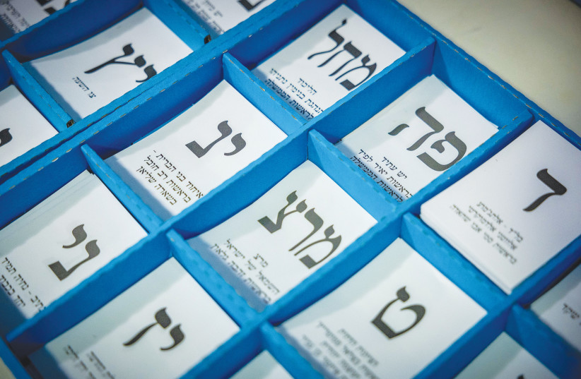  IN PREPARATION for tomorrow’s Knesset election, stubs of papers are placed in ballot boxes with the names of parties from which voters will choose. (photo credit: YONATAN SINDEL/FLASH90)