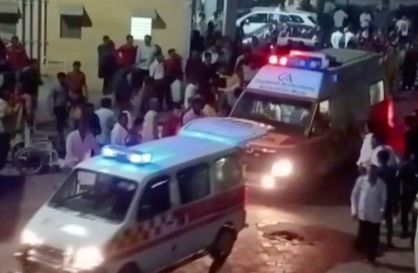  Ambulances arrive at a hospital following the collapse of a suspension bridge in Morbi, India October 30, 2022 in this screen grab obtained from a video. (credit: ANI/ Handout via REUTERS)