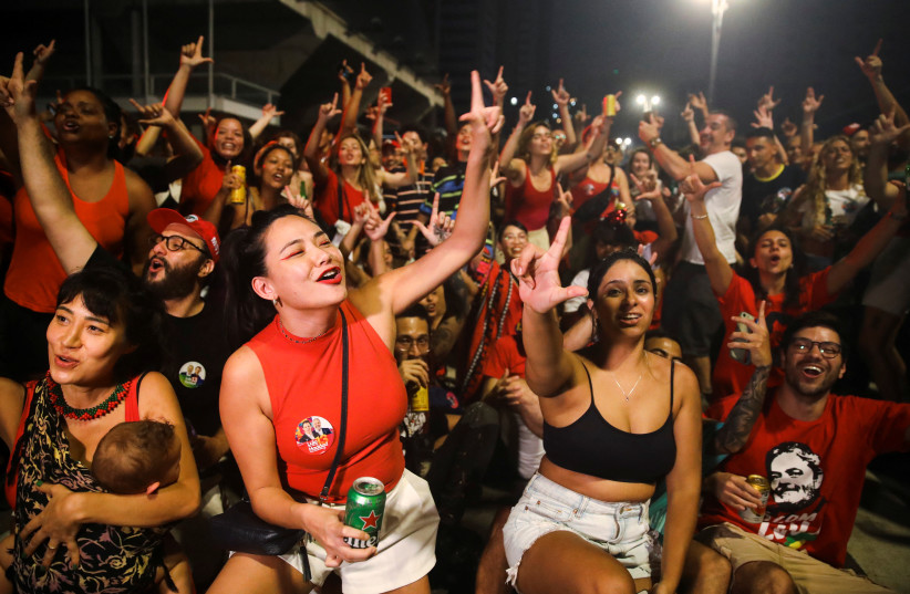  Supporters of Brazil's former President and presidential candidate Luiz Inacio Lula da Silva gesture at a gathering on the day of the Brazilian presidential election run-off, in Sao Paulo, Brazil October 30, 2022.  (credit: CARLA CARNIEL/REUTERS)