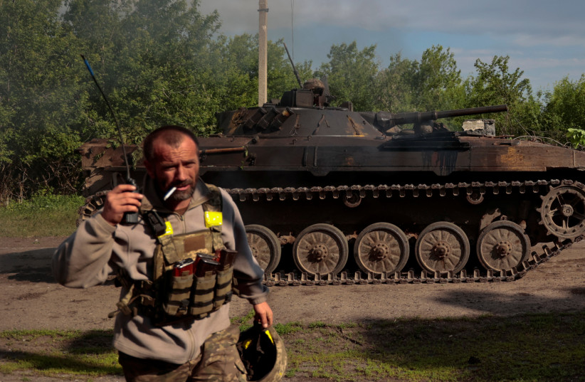  A Ukrainian serviceman speaks via mobile radio next to an armoured fighting vehicle, as Russia's invasion on Ukraine continues, near a frontline in Donetsk Region, Ukraine May 28, 2022. (credit: Serhii Nuzhnenko/Reuters)