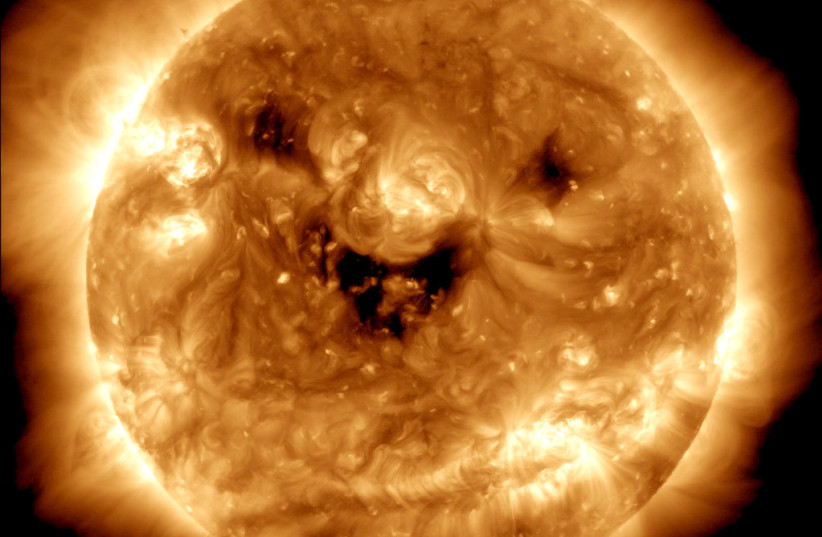  The NASA Solar Dynamics Observatory captires an image of the sun seemingly "smiling." (photo credit: NASA/GSFC/SDO)